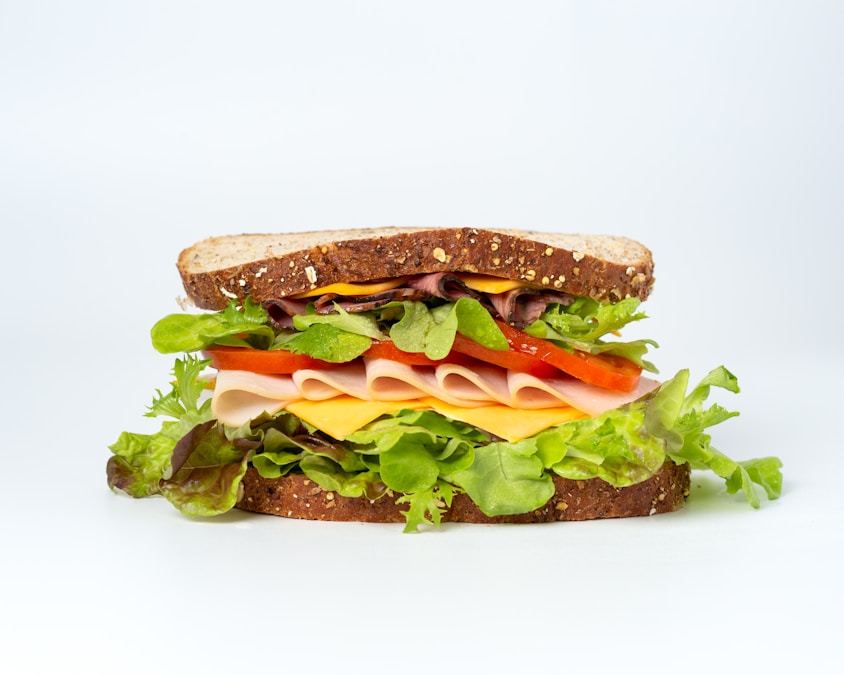 Fresh sandwich with fresh vegetables and bread on a wooden board