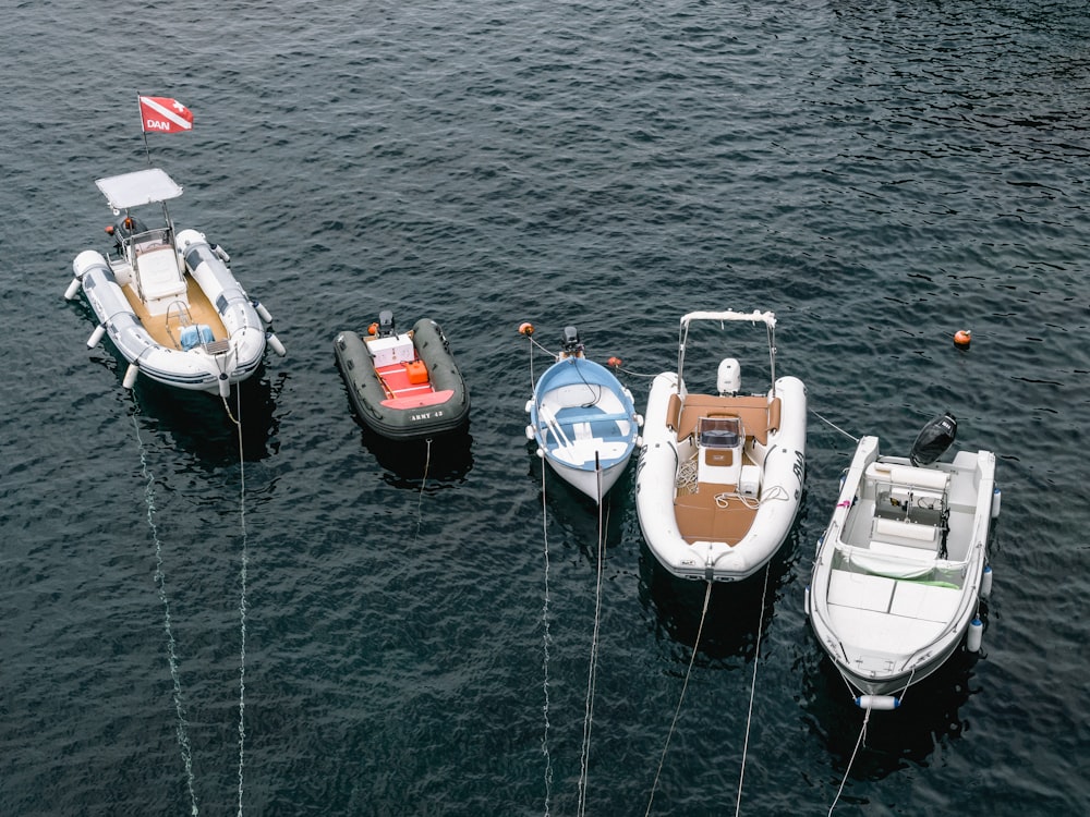 five boats on body of water