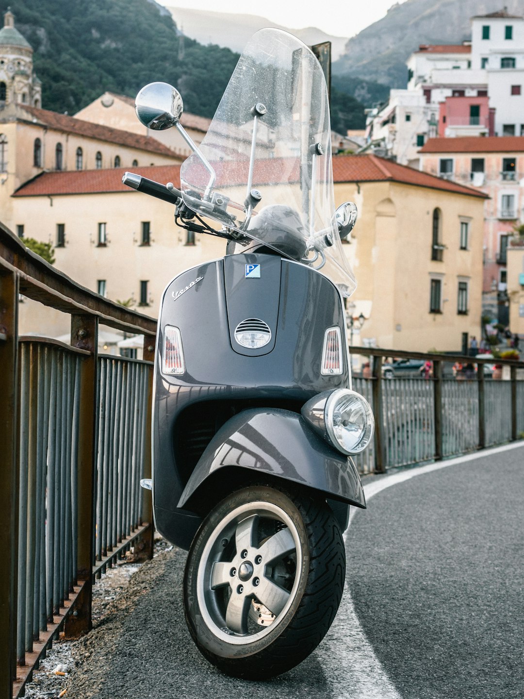 gray motor scooter parked on the street