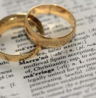 two gold-colored rings on paper