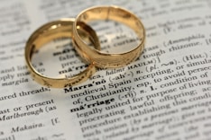 two gold-colored rings on paper
