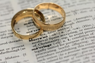 two gold-colored rings on paper