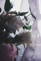 Close-up of a delicate pink and gold floral arrangement with soft natural light.