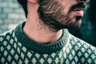 man wearing black and white knit sweater during daytime
