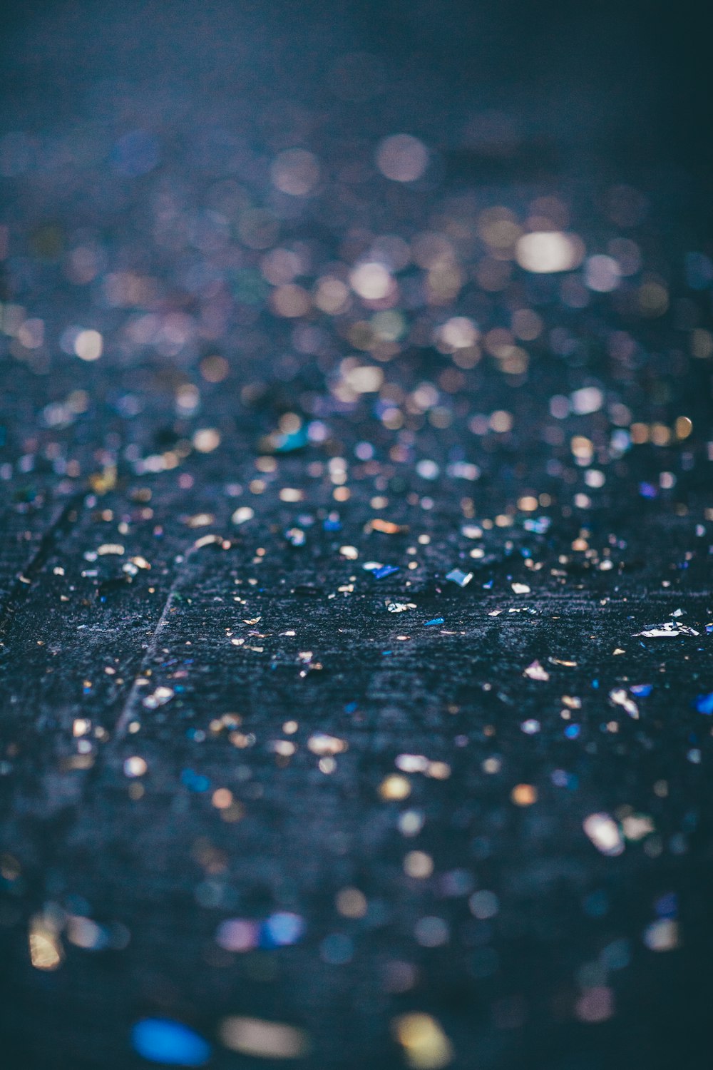 a close up of a black surface with lots of glitter