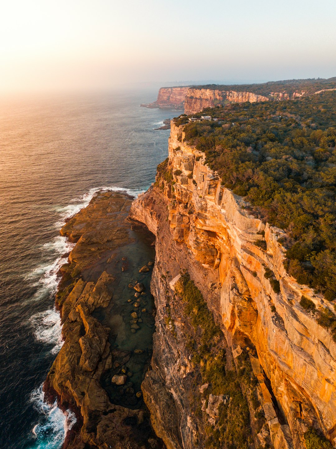 aerial photography of mountain beside sea