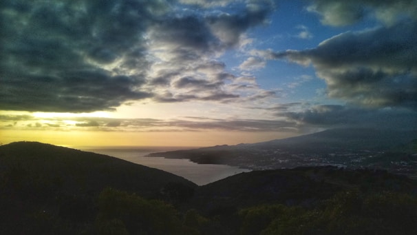 A scenic view of a coastal property with a beautiful sunset.
