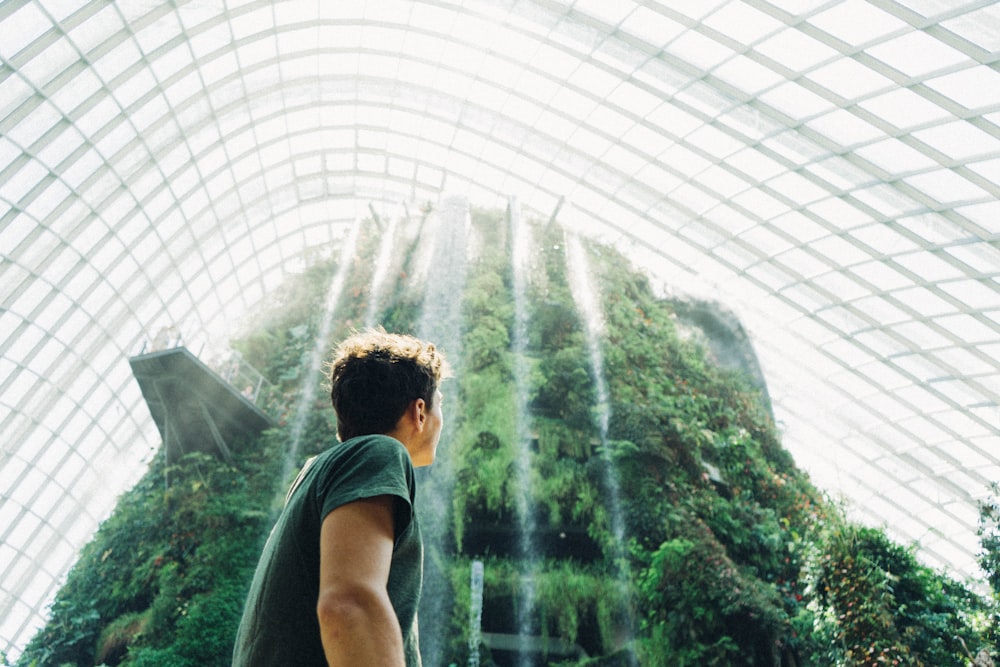 man standing in front of waterfalls