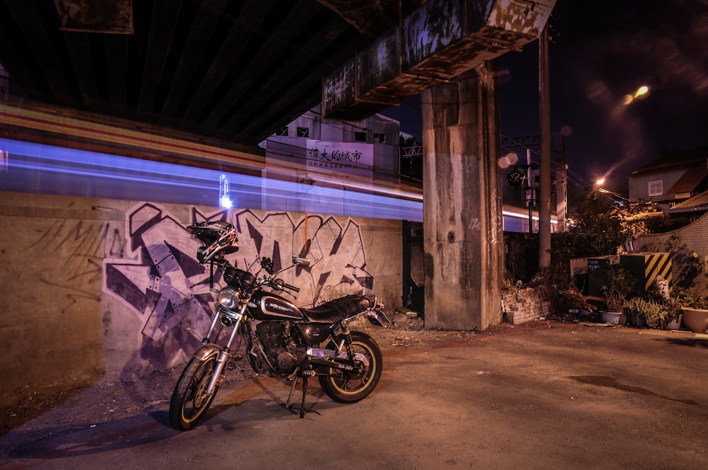 motorcycle parked near graffiti