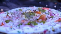 A close-up of freshly made injera with vibrant toppings.