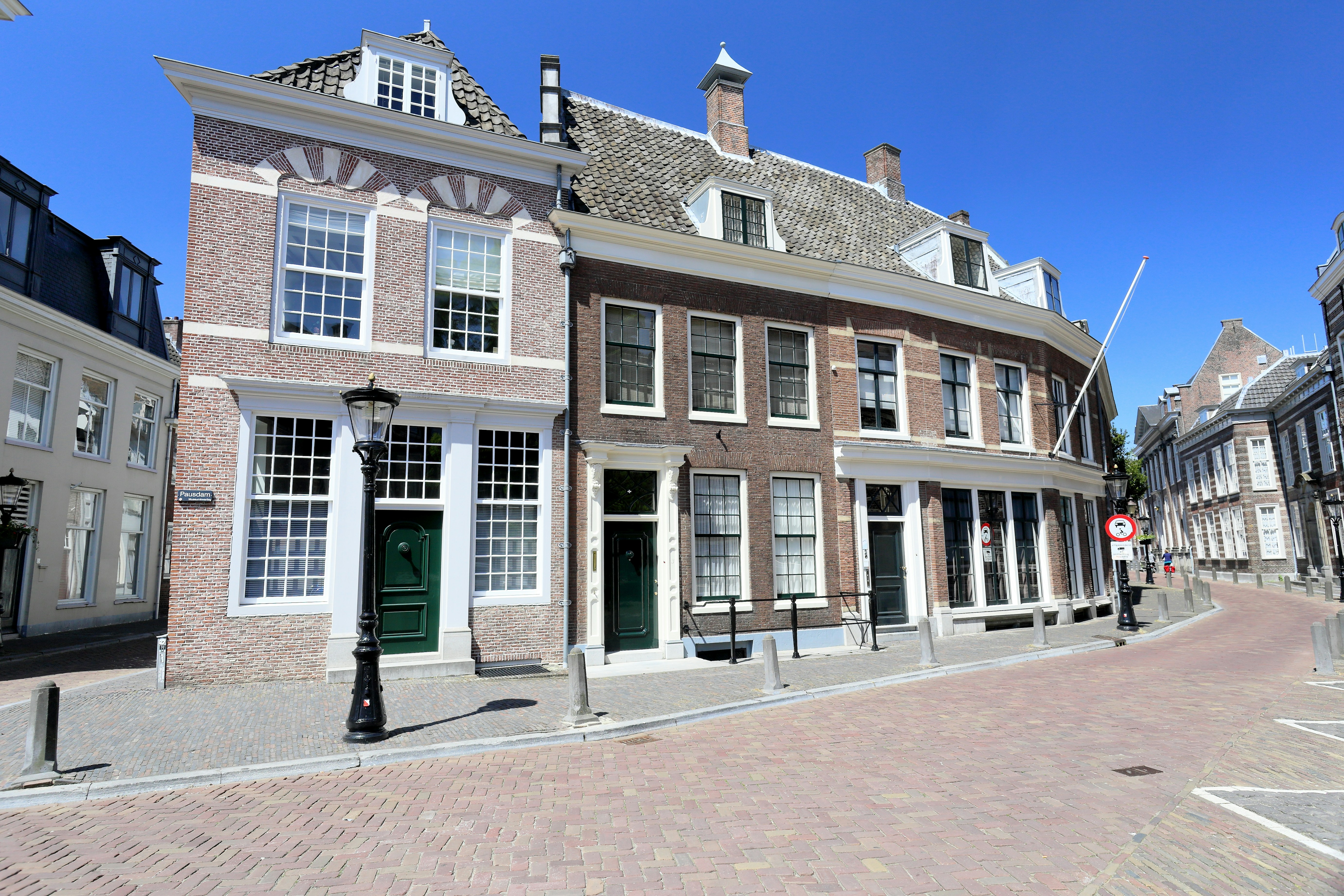 a row of brick buildings on a cobblestone street