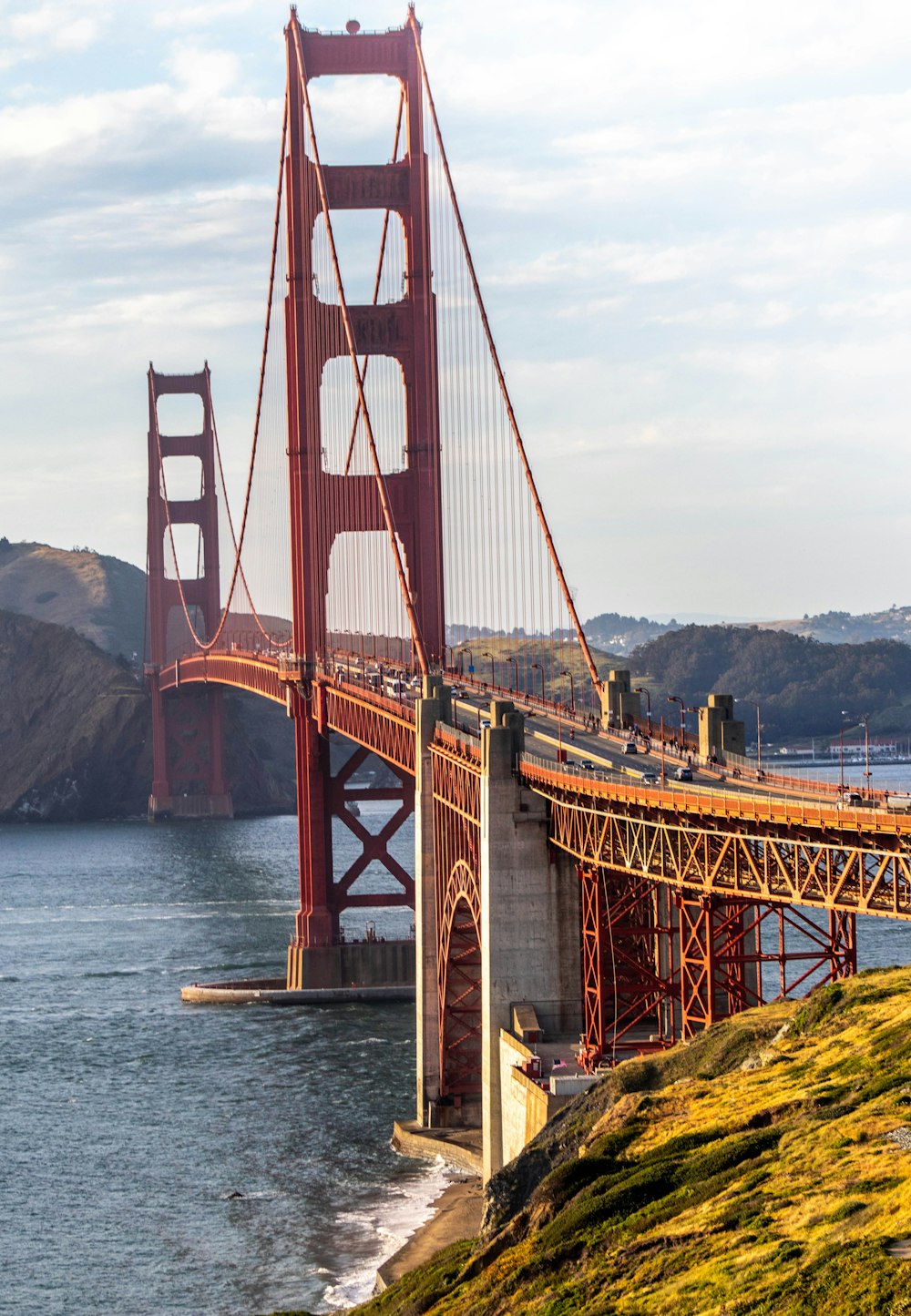 brown metal bridge under blue body water during daytime