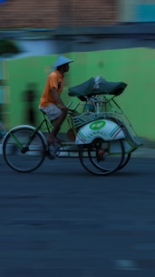 A cycle rickshaw driver happily receiving his new rickshaw from SMV Wheels staff.