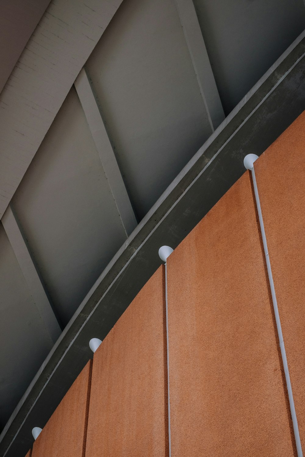 grey roof above brown wooden wall