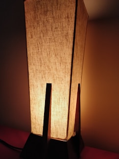 Close-up of a concrete base with warm light glowing softly from a 3D printed lampshade.