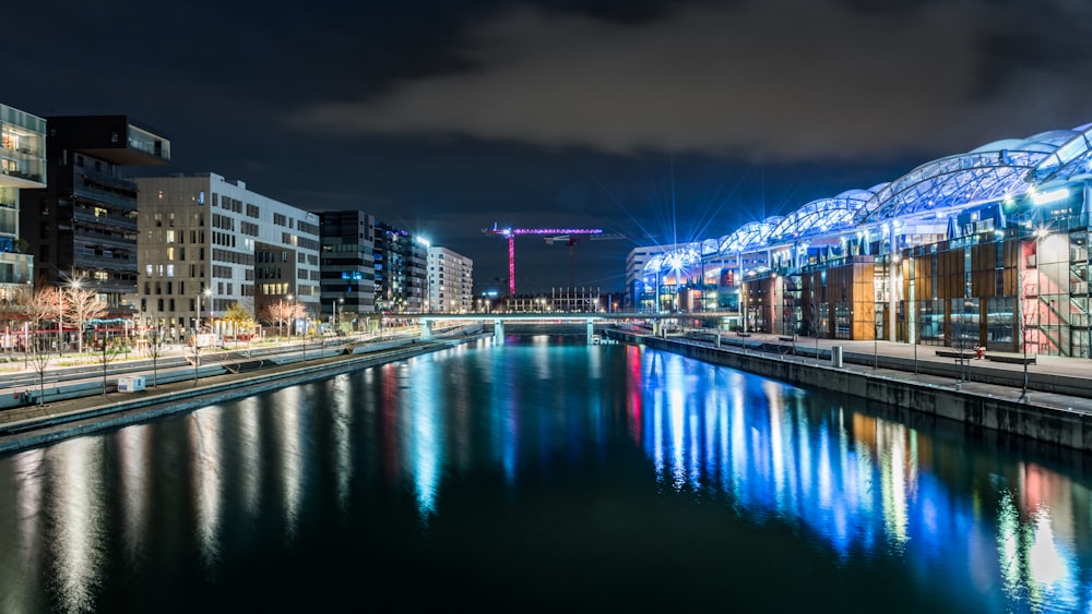 lights reflecting on glassy river at the city