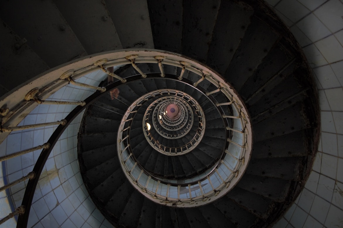 architectural photography of black and gray spiral stair