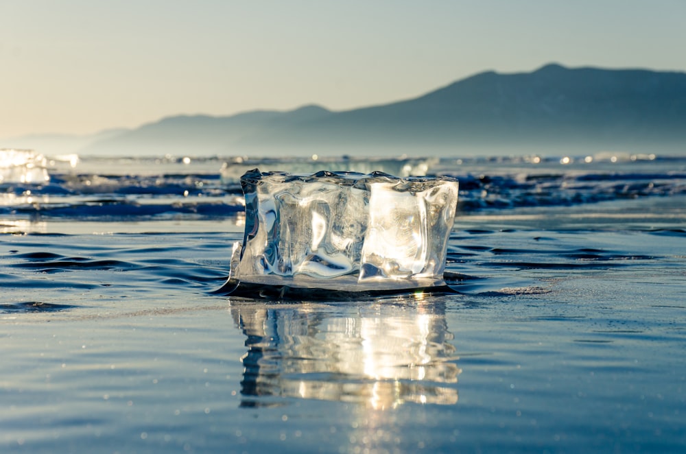 ice block on calm body of water during daytime