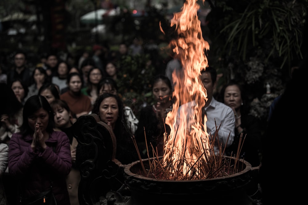 group of people standing near fire