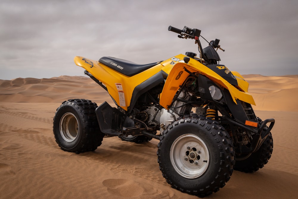 yellow and black ATV under cloudy sky