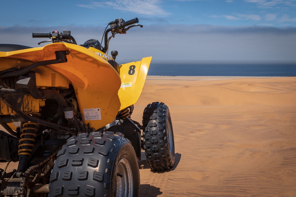 shallow focus photography of yellow and black ATV