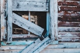 Boarded-up window with a neat, secure wooden frame after damage.