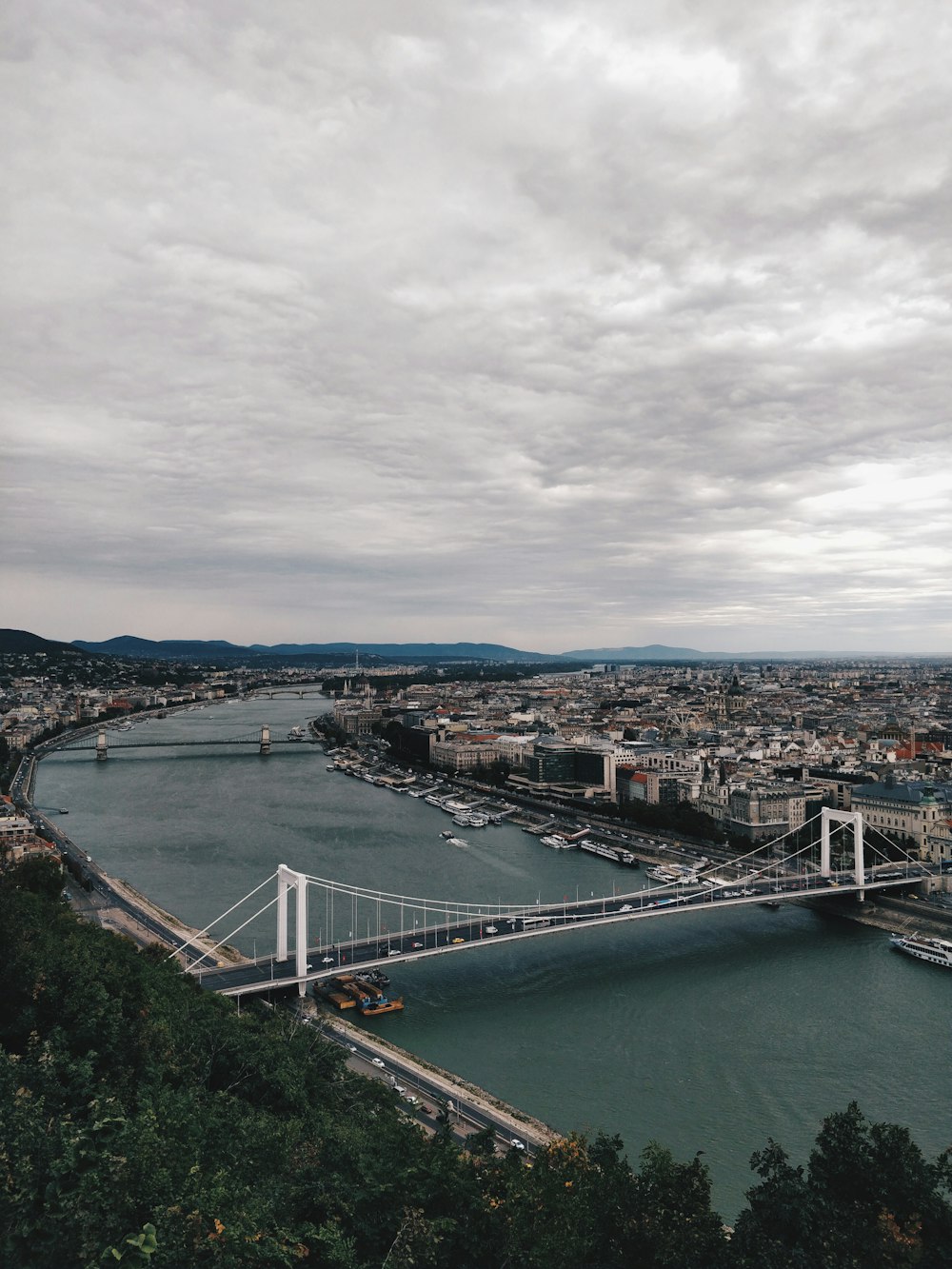 white concrete bridge above body of water