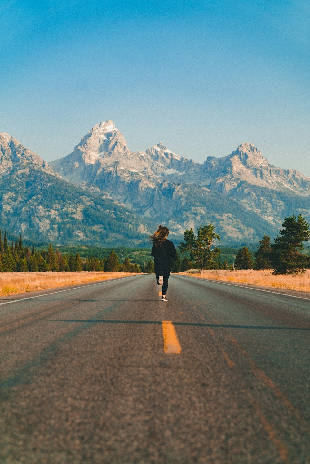 woman walking on road during daytime