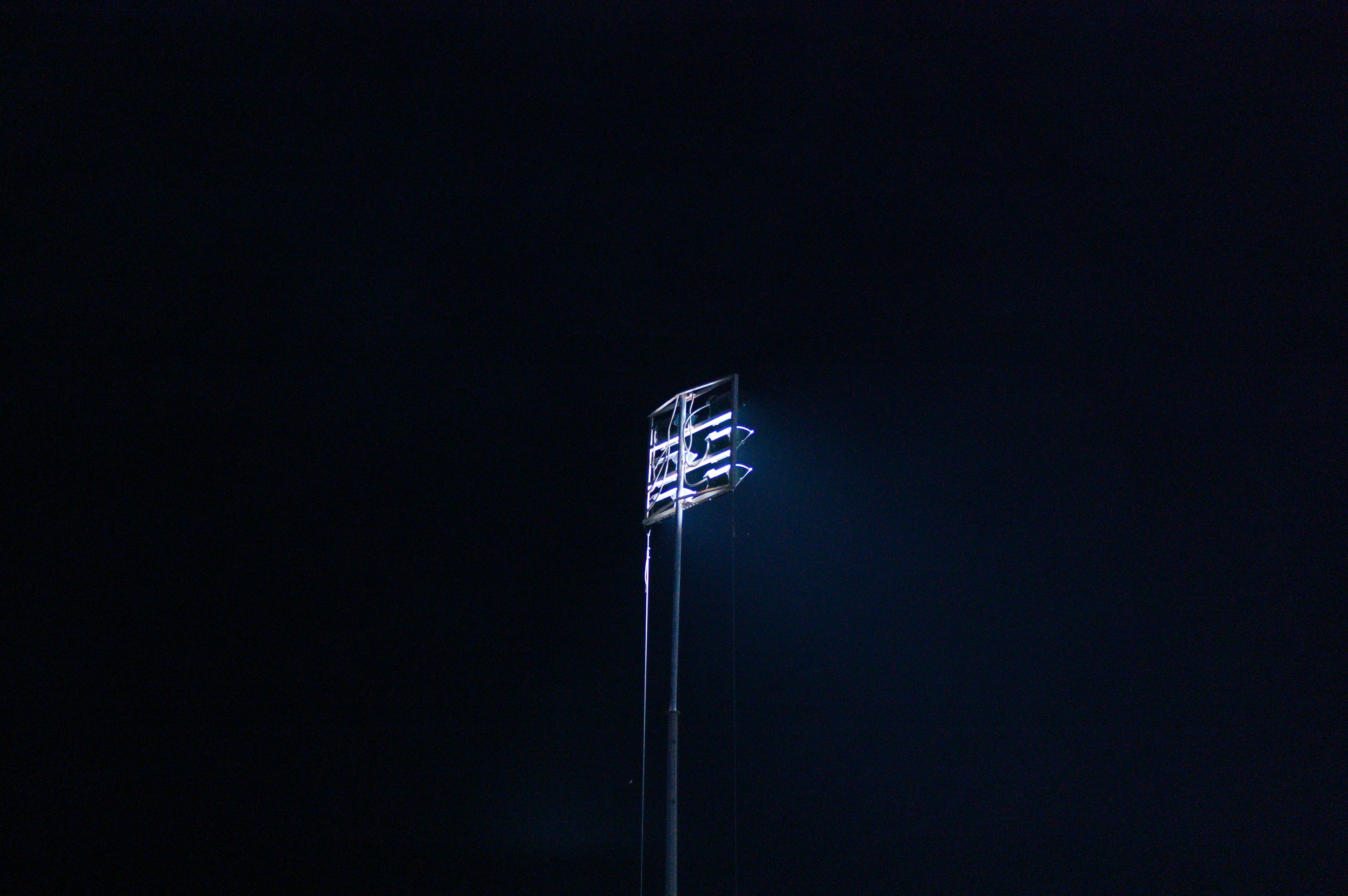 a street light in the dark with a sky background