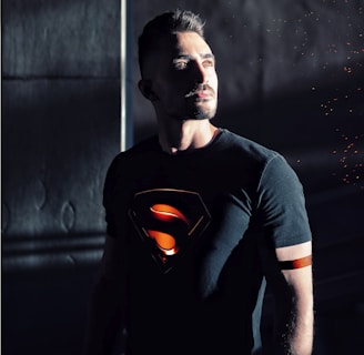 man wearing black Superman shirt
