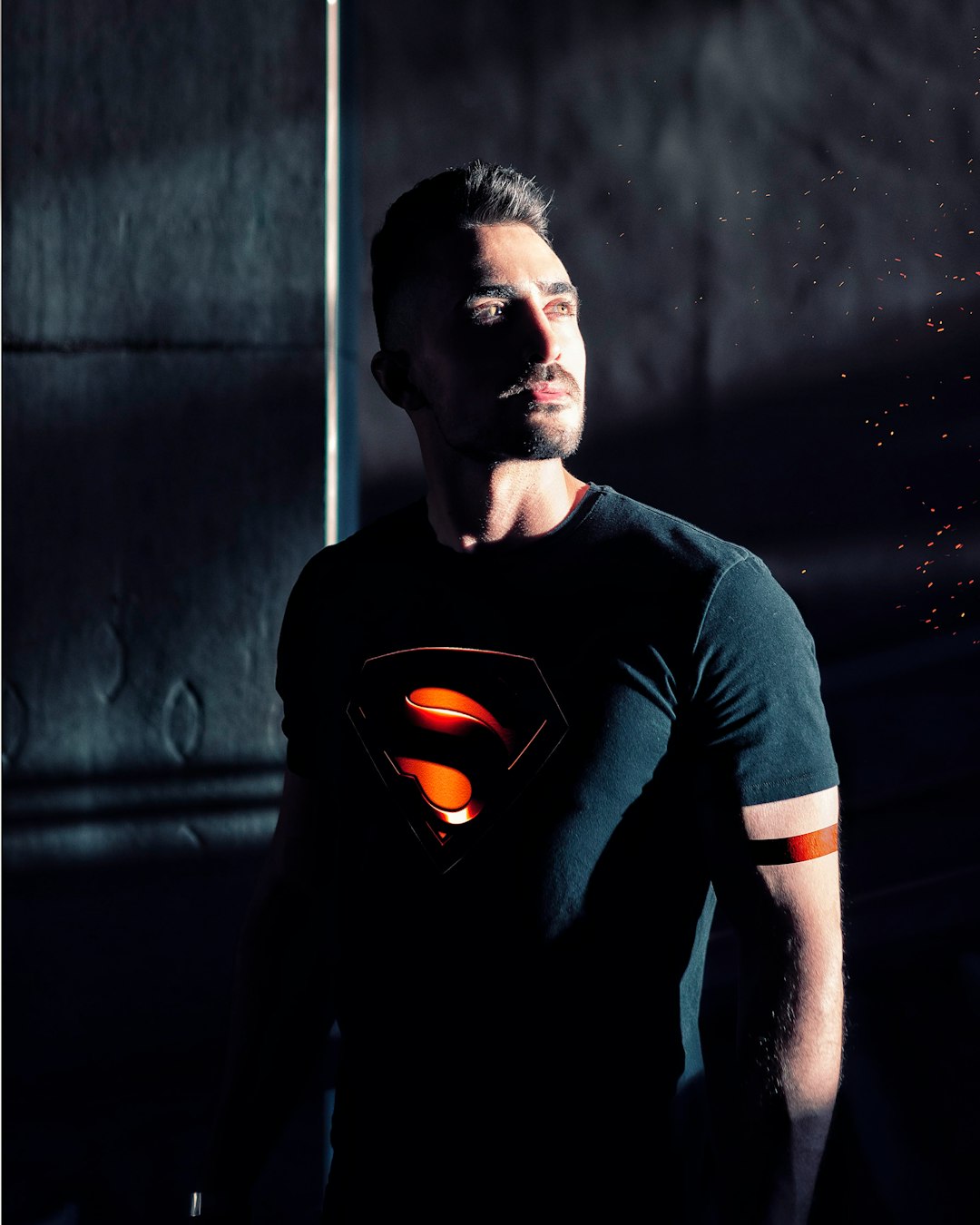 man wearing black Superman shirt