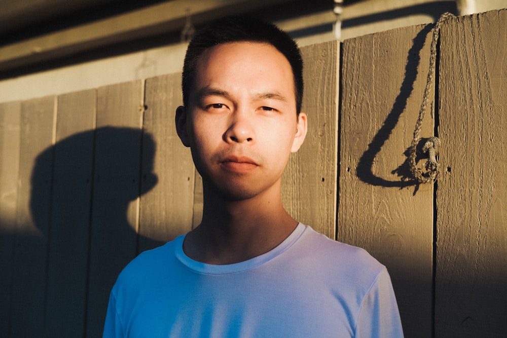 man in white crew-neck shirt near wall