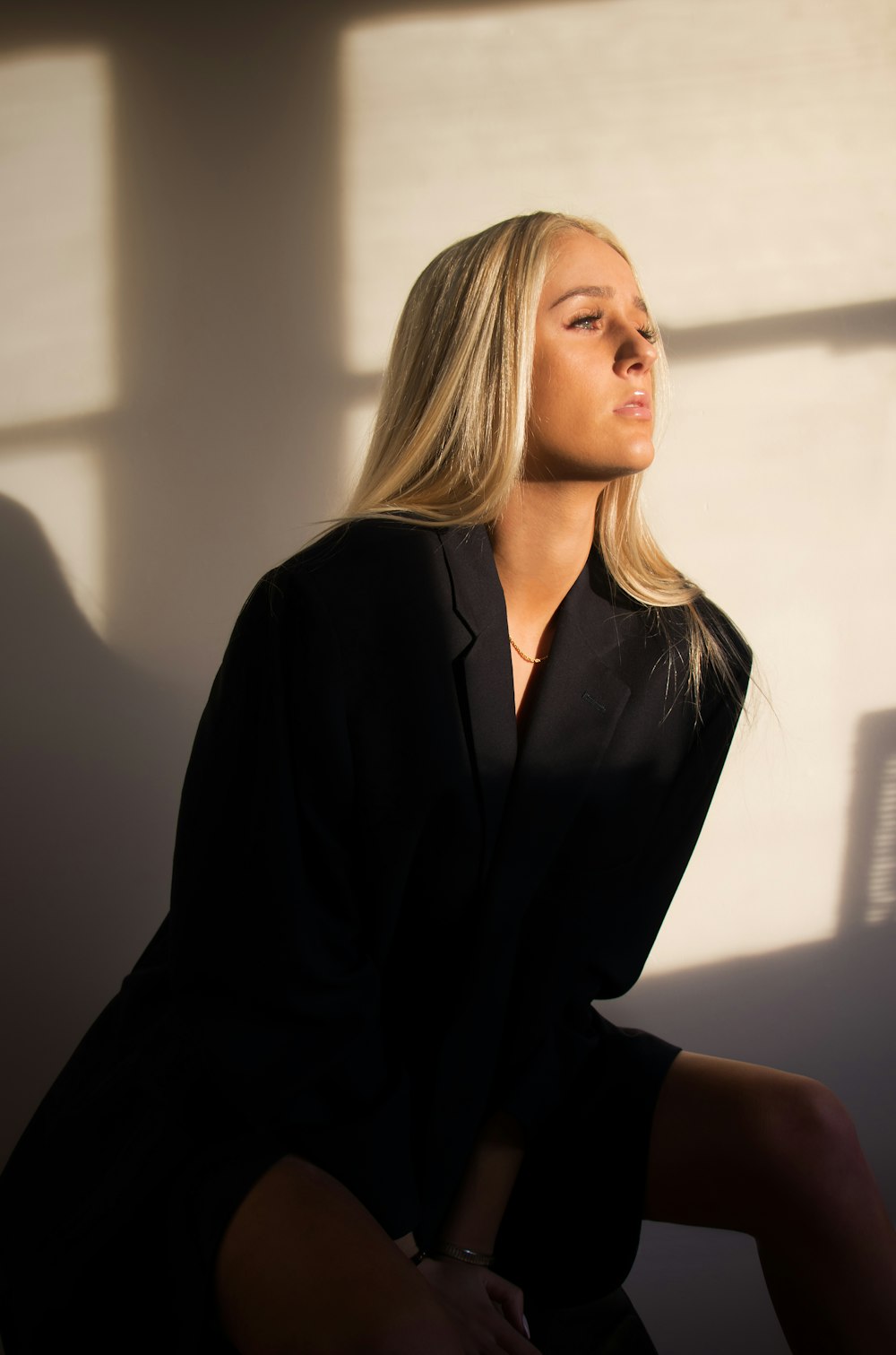 woman sitting on chair while wearing black top