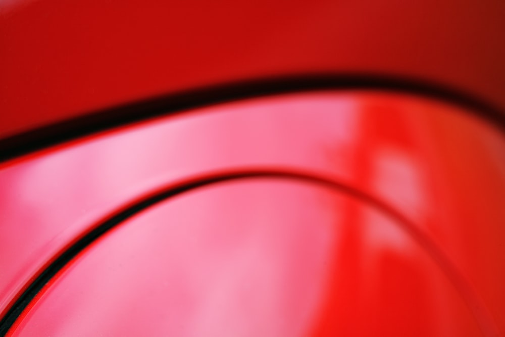 a close up of a red car door handle