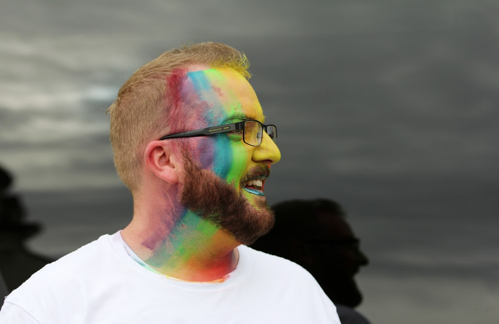 smiling man wearing eyeglasses facing his right side