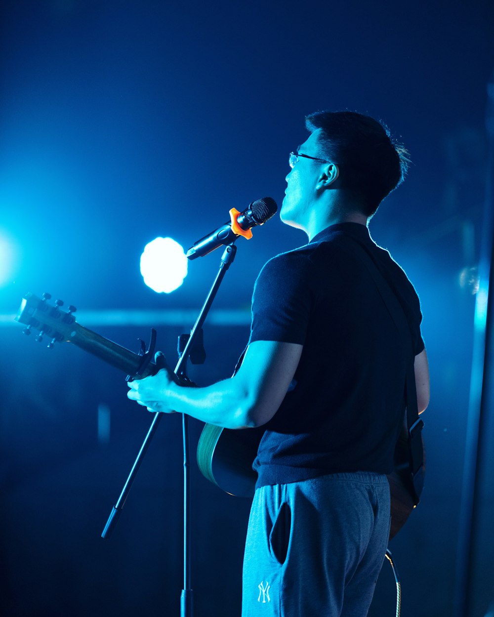 man playing guitar while singing