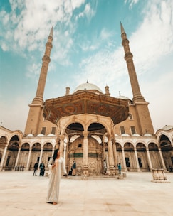 woman standing near mosque during daytime