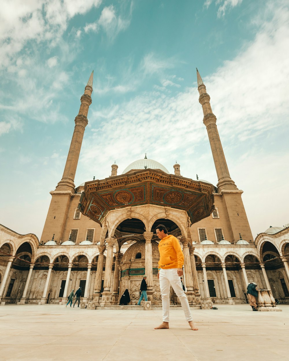 man standing near mosque