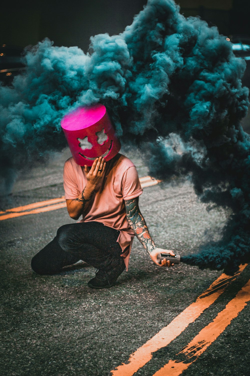 man wearing mask making blue smoke