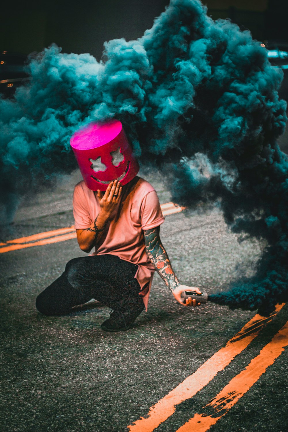man wearing mask making blue smoke