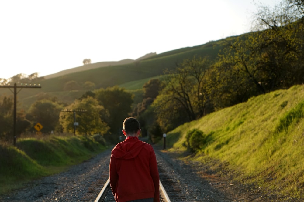 man standing on rail track