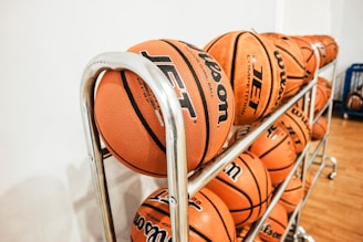 pile of basketballs beside wall