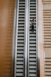 Senior smiling while safely using the elevita escalator on stairs.