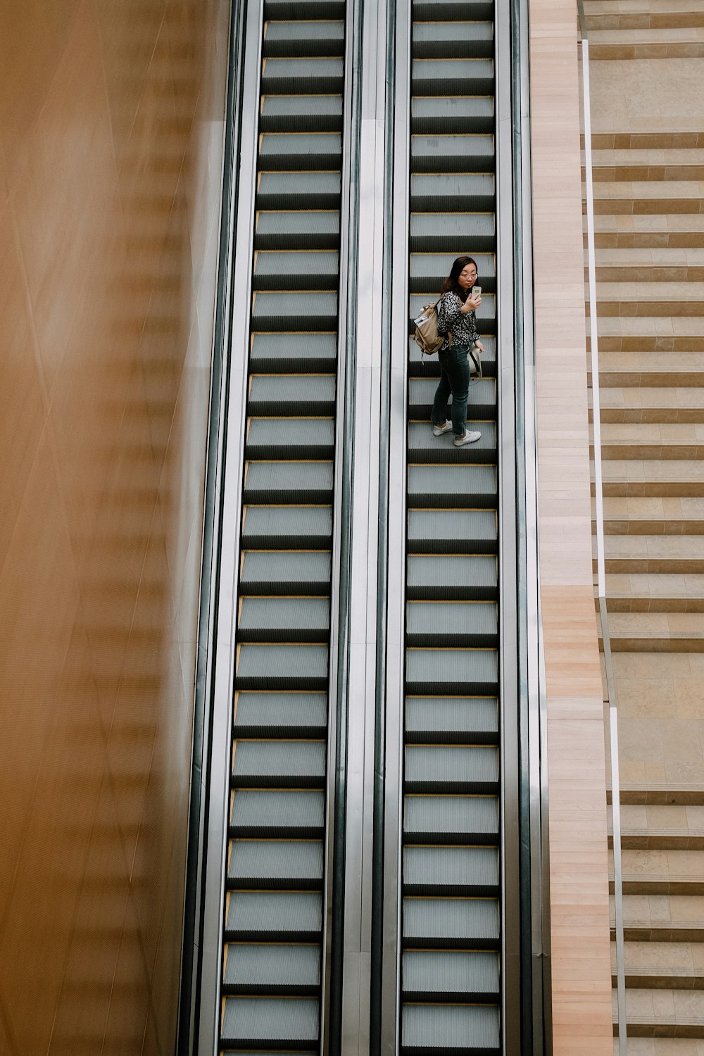 high-angle photography of person on escalator