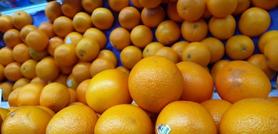 A bunch of vibrant oranges arranged in a line.