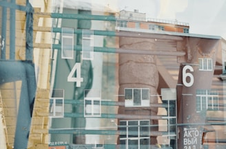 a number of windows with a building in the background