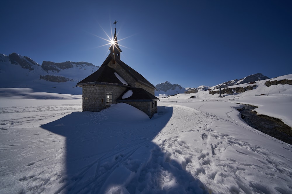 church in snow field during daytime