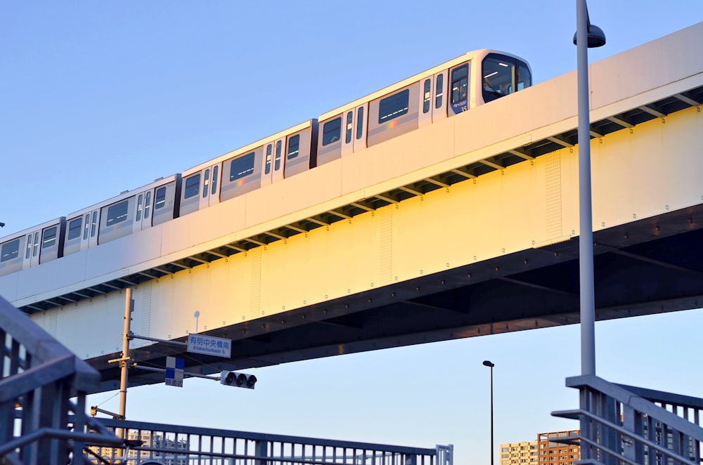 white subway on concrete bridge during daytime