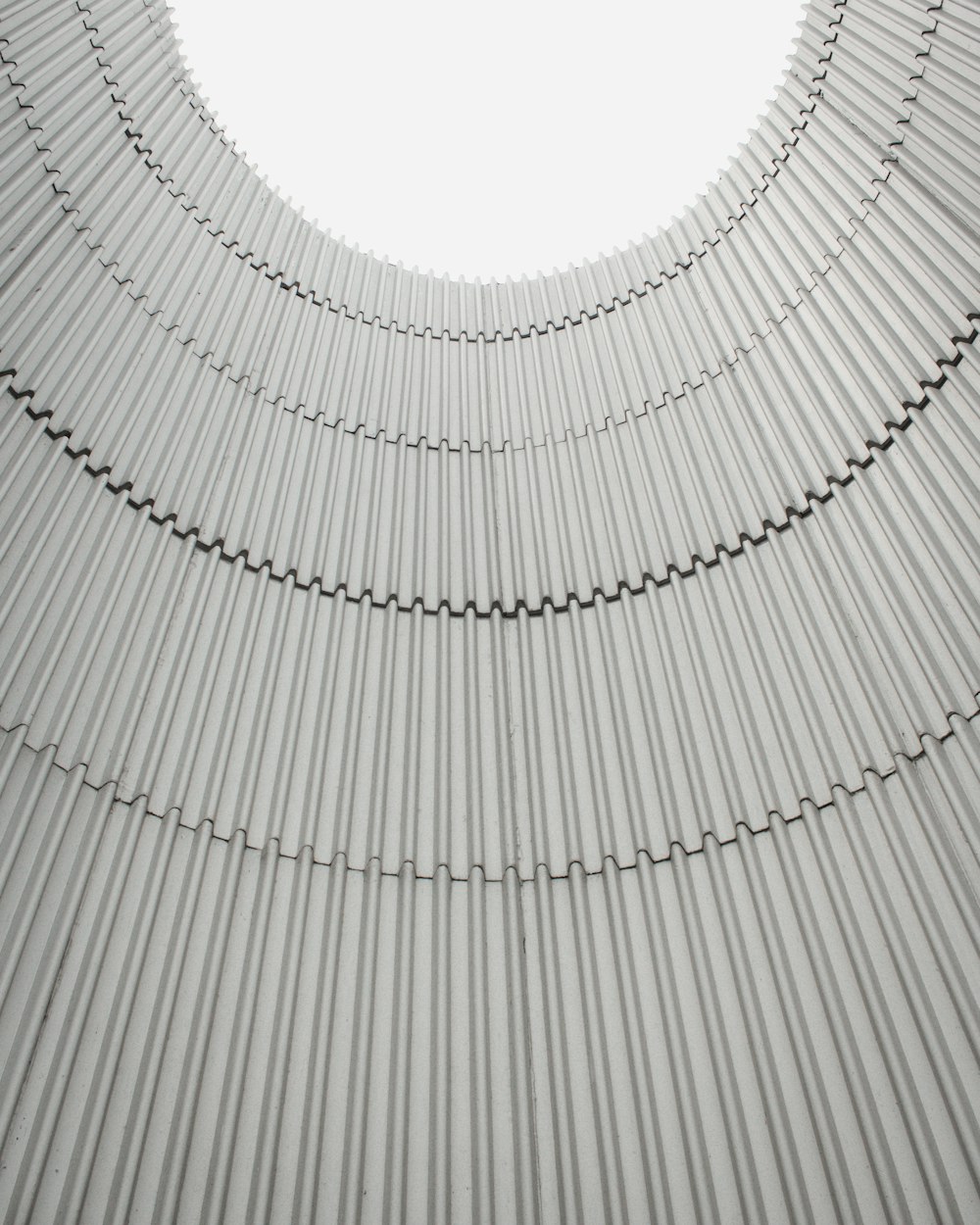 a circular metal structure with a white sky in the background