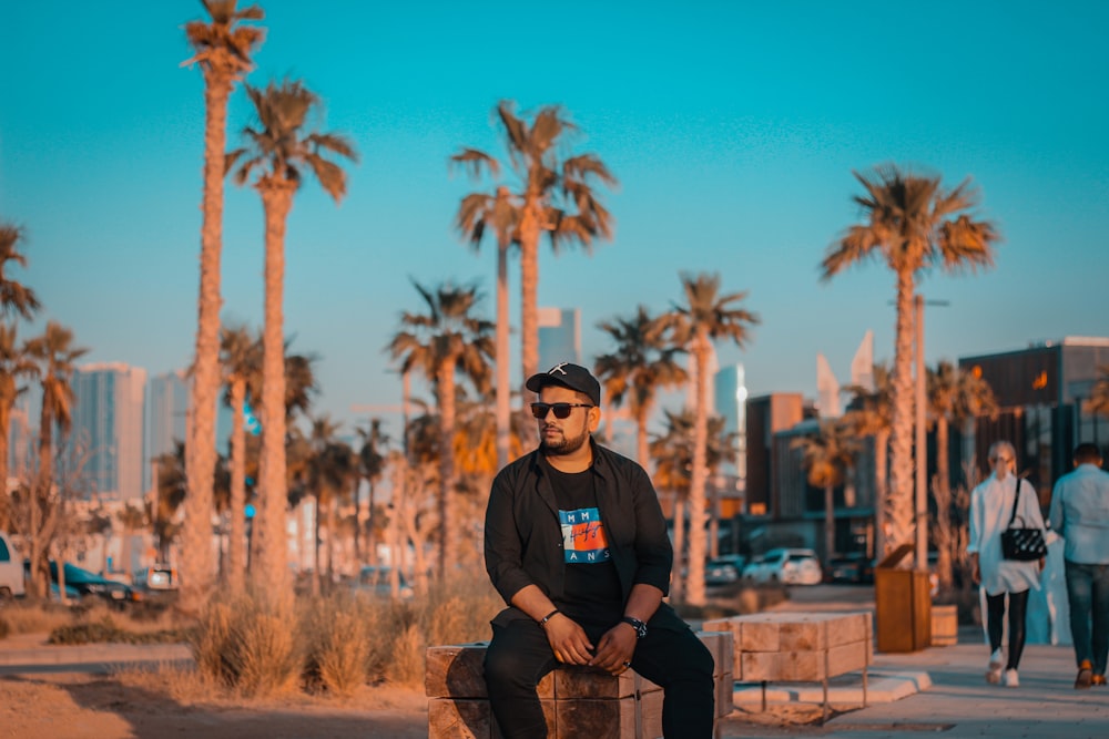 man in black jacket sitting on the bench